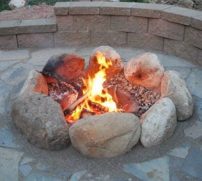 FIre ring with large beach rocks and smaller black pebbles inside